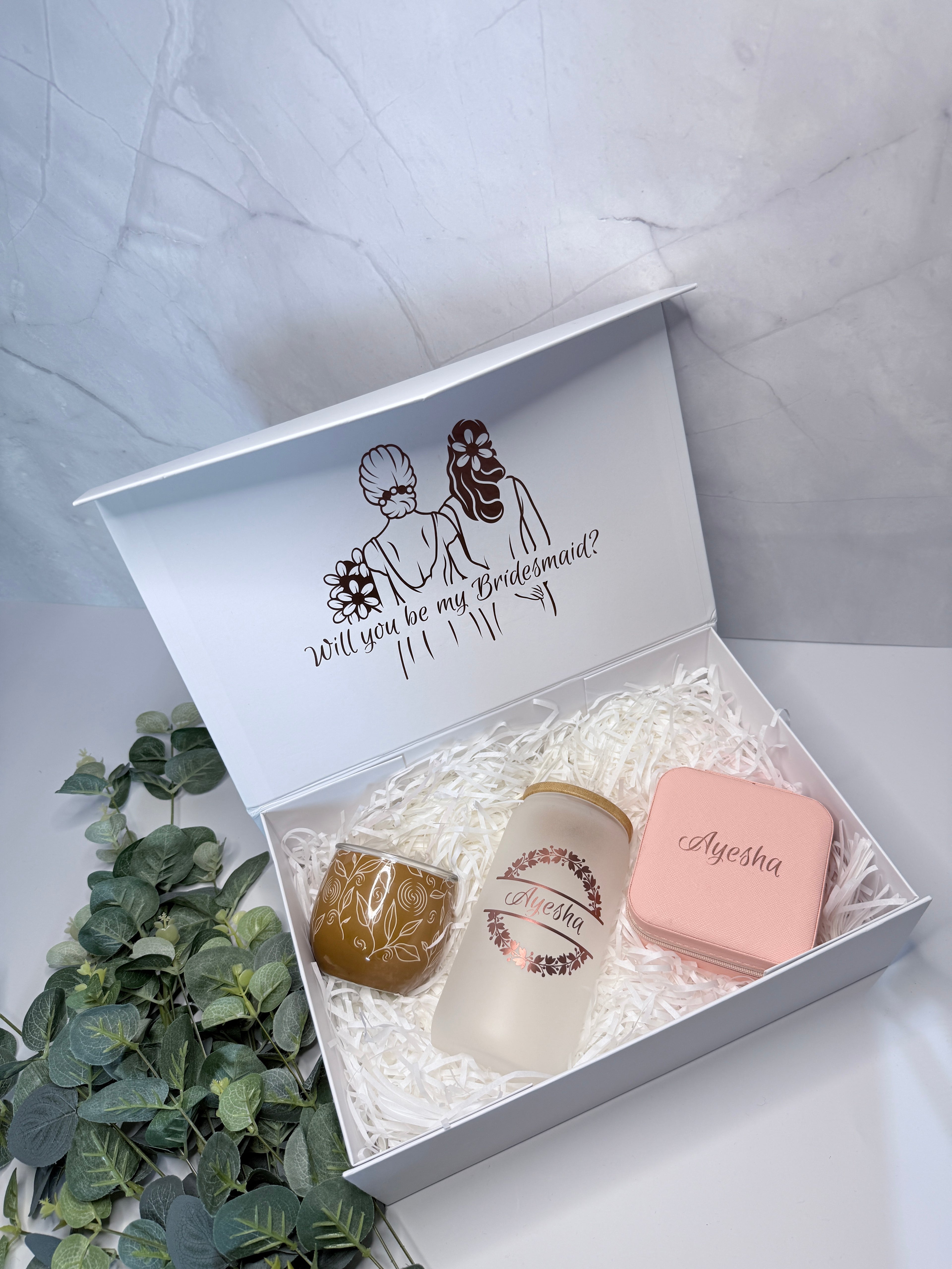 Gift box with personalized items on a light gray background